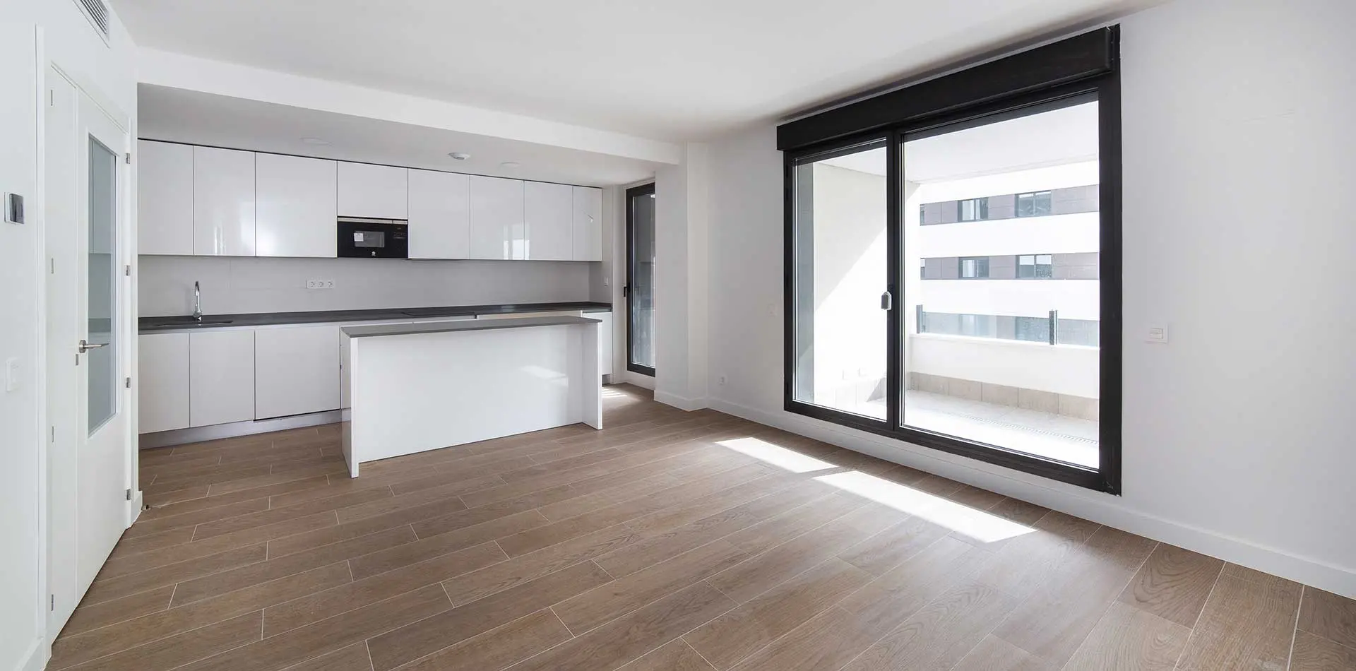 Salón y cocina de una vivienda de la promoción Nature Living en Tres Cantos